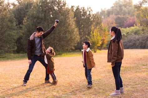 40+ Young Family Playing Game And Laughing In Park Stock Photos ...