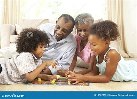 Family Playing Board Game at Home Stock Photo - Image of sitting ...