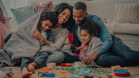 Premium Photo | A family playing a board game together on the floor