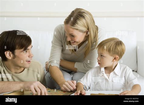 Family playing board game together Stock Photo - Alamy
