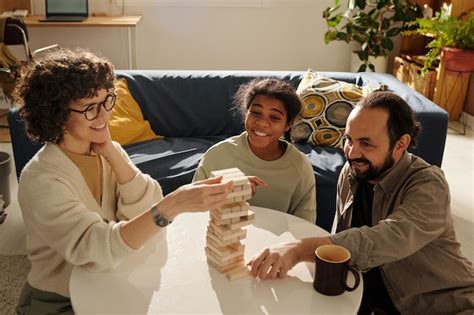 Premium Photo | Family playing board game together