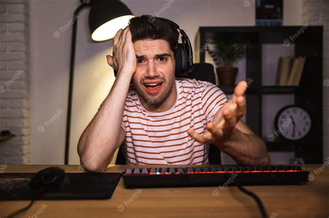 Premium Photo | Confused gamer playing video games on computer