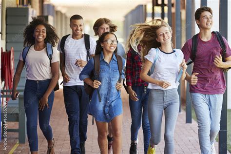 Teenager school kids running in high school hallway Stock Photo | Adobe ...