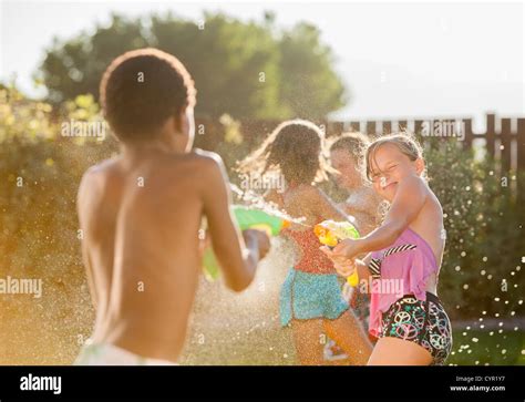 Children playing water fight hi-res stock photography and images - Alamy