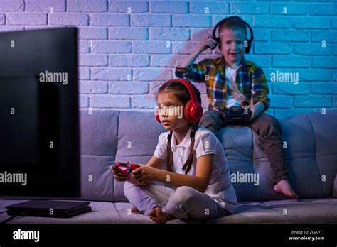 children playing video game with game console Stock Photo - Alamy