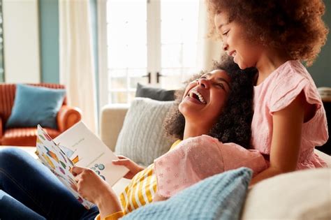 Premium Photo | Mother And Daughter Relaxing On Sofa At Home Reading ...