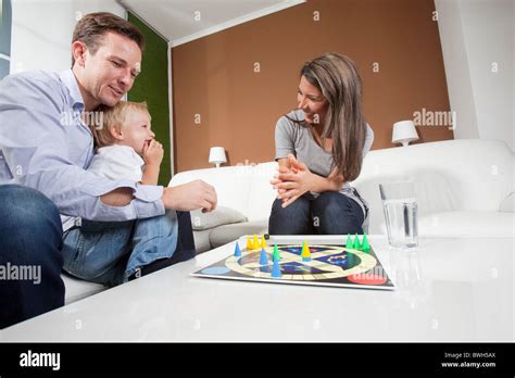 Family playing board game Stock Photo - Alamy