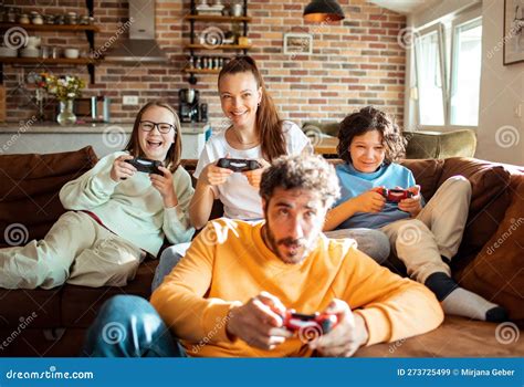 Young Family Playing Video Games Together in the Living Room on a ...
