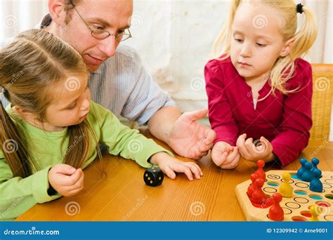 Family Playing a Board Game Stock Photo - Image of child, game: 12309942