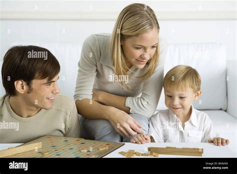 Family playing board game together Stock Photo - Alamy