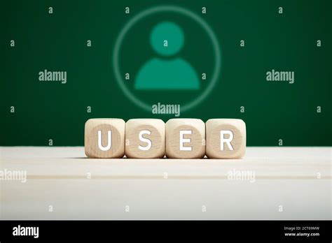 The word user on wooden blocks with a user icon on green background ...