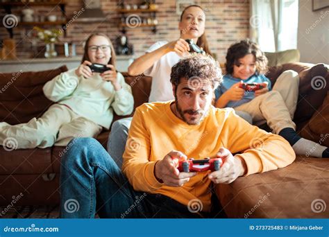 Young Family Playing Video Games Together in the Living Room on a ...