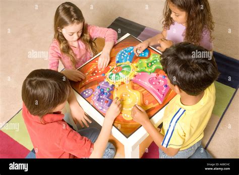Portrait of kids playing a board game Stock Photo - Alamy