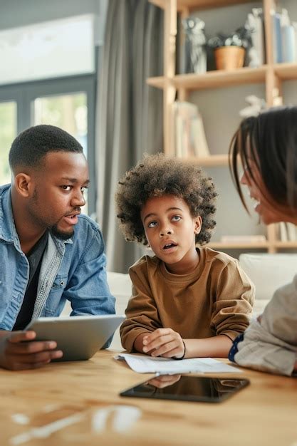 Parents discussing screen time limits with child tablet on table ...