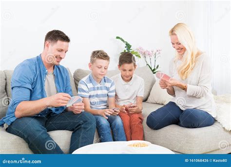 Happy Young Family Playing Card Game at Home. Stock Photo - Image of ...