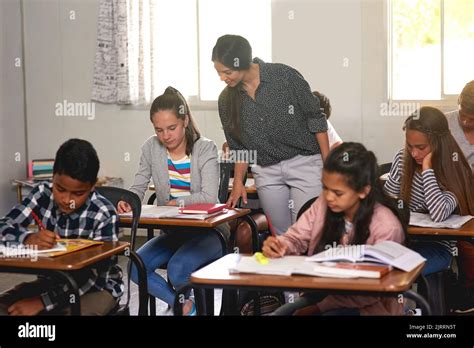 Teacher checking book hi-res stock photography and images - Alamy