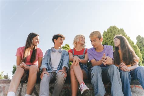 Premium Photo | Group of smiling teenagers talking communication ...
