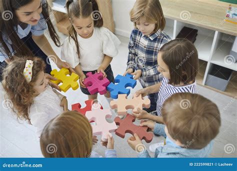 Team of Preschoolers or School Kids with Teacher Put Together Pieces of ...