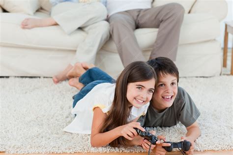 Premium Photo | Children playing videogames while parents are talking