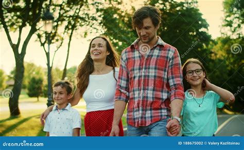 Positive Family Walking on Street. Cheerful Kids and Parents Laughing ...