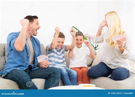 Happy Family Playing Card Game on Living Room Sofa at Home and Having ...