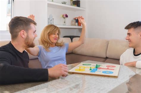 Premium Photo | Family Enjoying a Competitive Board Game