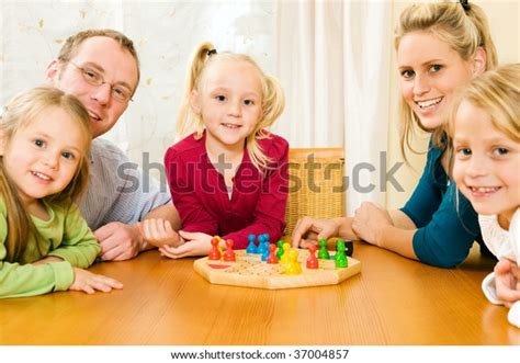 Family Playing Board Game Together Having Stock Photo (Edit Now) 37004857