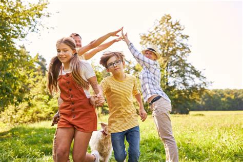 Parents and Two Children Play a Game Together a Stock Image - Image of ...