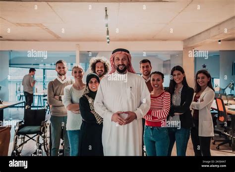 A diverse group of successful business people in a modern glass office ...