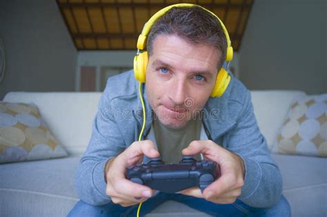 Lifestyle Portrait of Young Happy and Excited Gamer Man with Headphones ...