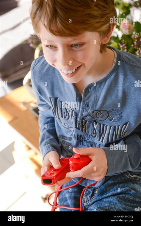 Child playing with video game Stock Photo - Alamy