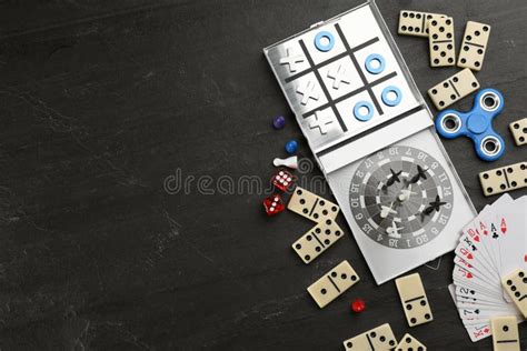 Elements of Different Board Games on Black Slate Table, Flat Lay. Space ...