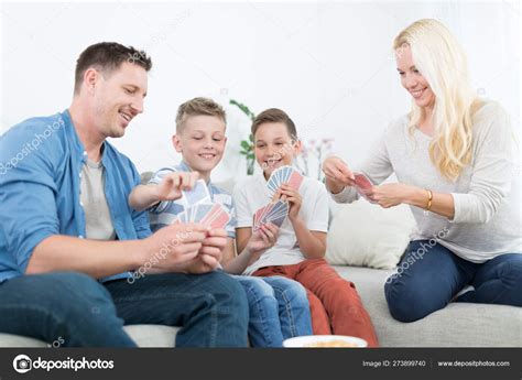 Happy young family playing card game at home. — Stock Photo © kasto ...