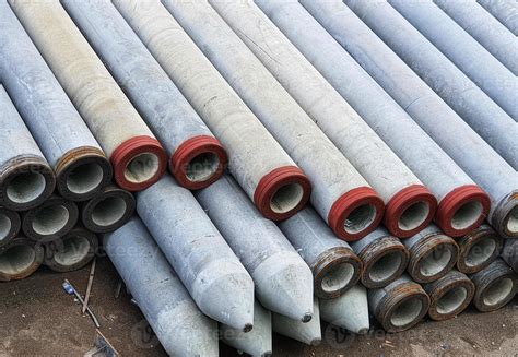 Pile of concrete spun pile in a stockyard. 11002982 Stock Photo at Vecteezy