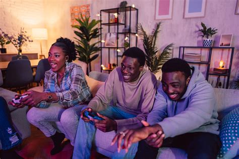 Black Family Playing Video Games Together In The Living Room Stock ...