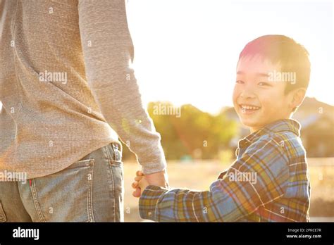 A parent and child going outside to play together Stock Photo - Alamy