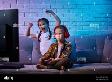 children playing video game with game console Stock Photo - Alamy