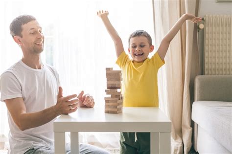 Premium Photo | Happy family playing board game together. Home. Cozy.