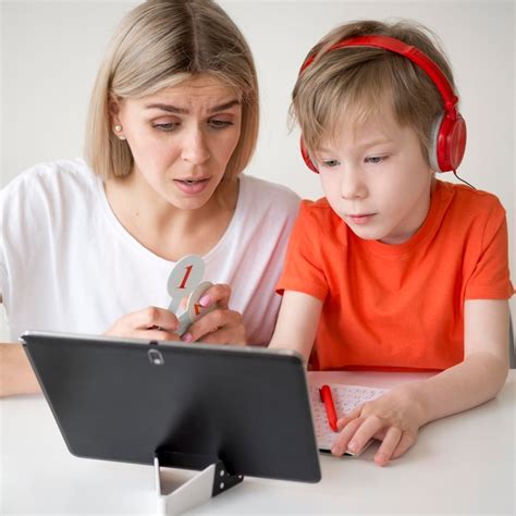 Premium Photo | Mother and child looking at a tablet