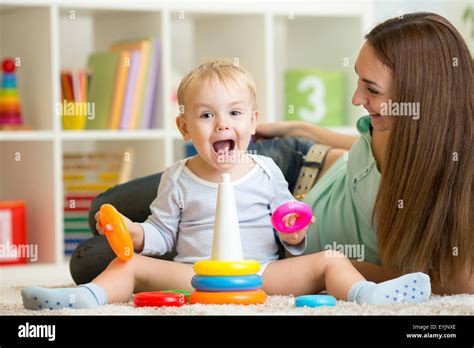 parent and child boy playing together at home Stock Photo - Alamy