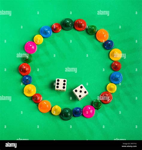 Colorful game pieces and dice Stock Photo - Alamy