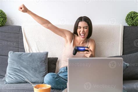 Young woman playing online video games - Happy gamer having fun on new ...