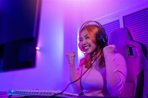 Premium Photo | Happy gamer young plays online video games computer she ...