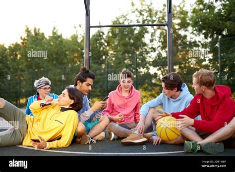 young basketball players take a break after game, have fun and talk. in ...