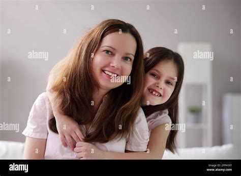 Happy Mom Embracing Smiling Child. Kid Hug Stock Photo - Alamy