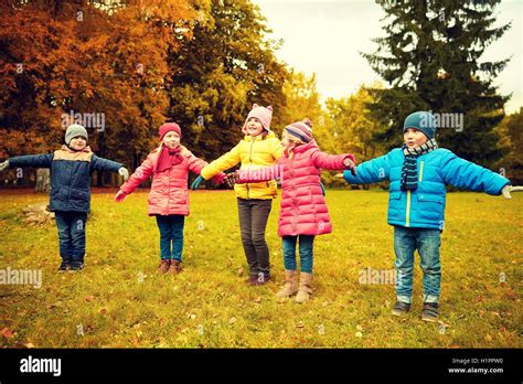 happy little children running and playing outdoors Stock Photo - Alamy