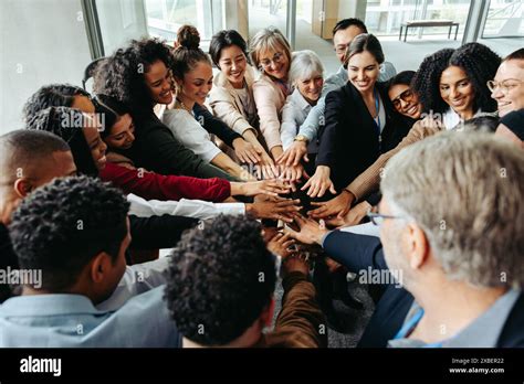 Diverse team demonstrating teamwork and inclusion at a conference ...