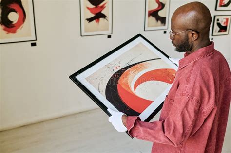 Man Examining Abstract Painting in Art Gallery Stock Photo - Image of ...