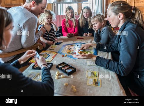 Family playing board game Stock Photo - Alamy