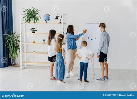 Explaining Lesson and Using Board. Group of Children Students of ...